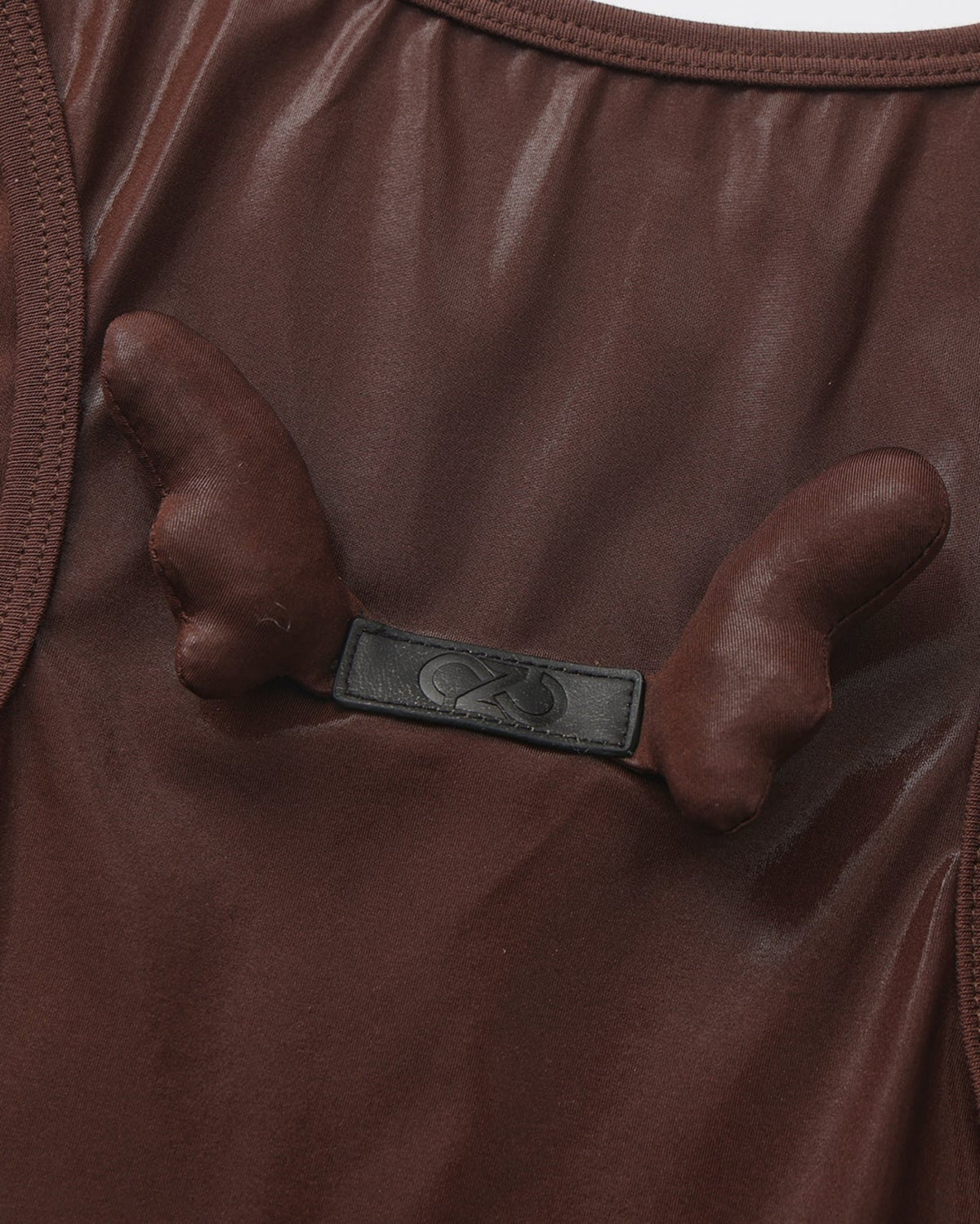 Close-up of the paired sculptural detail on the BSZN upper-back logo tab