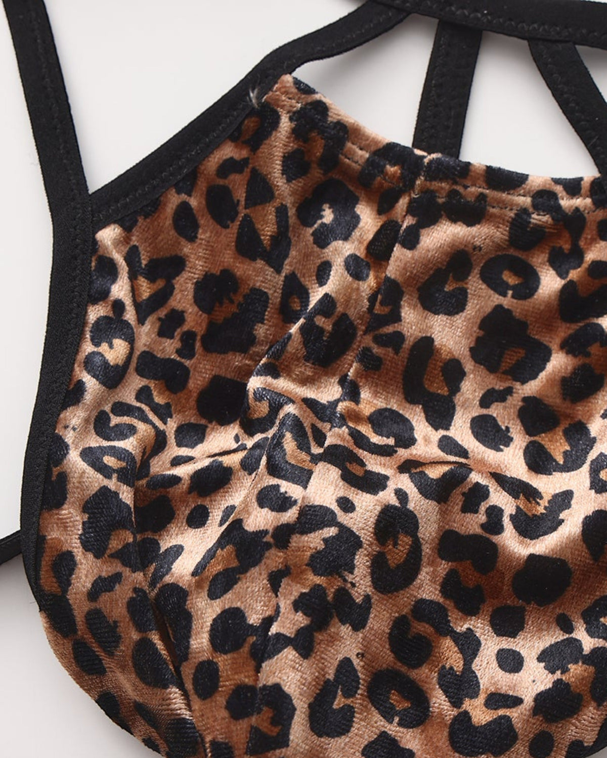 Close-up of the leopard pouch seam and black binding on the BSZN cage thong
