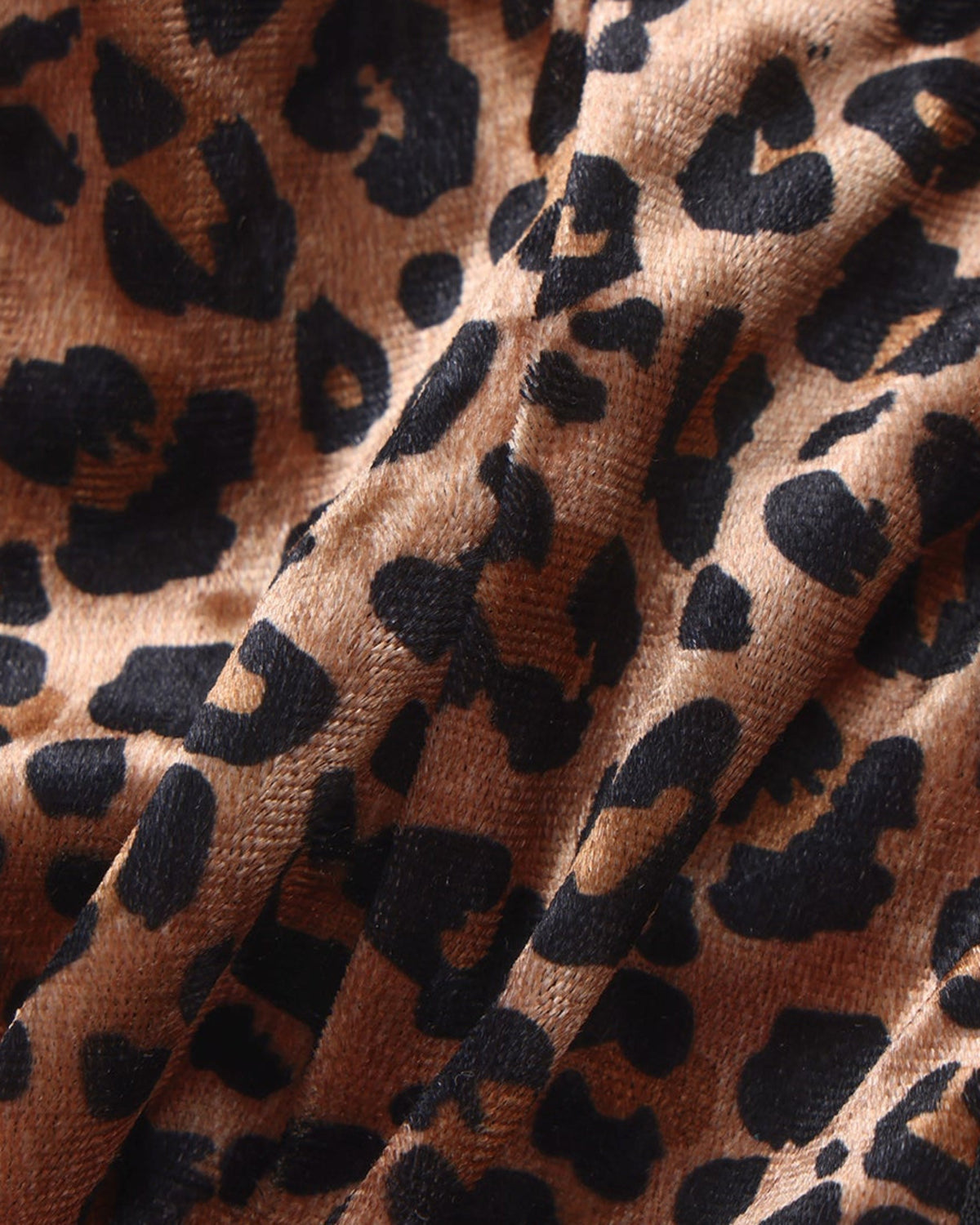 Close-up of the brown leopard stretch fabric on the BSZN cage thong