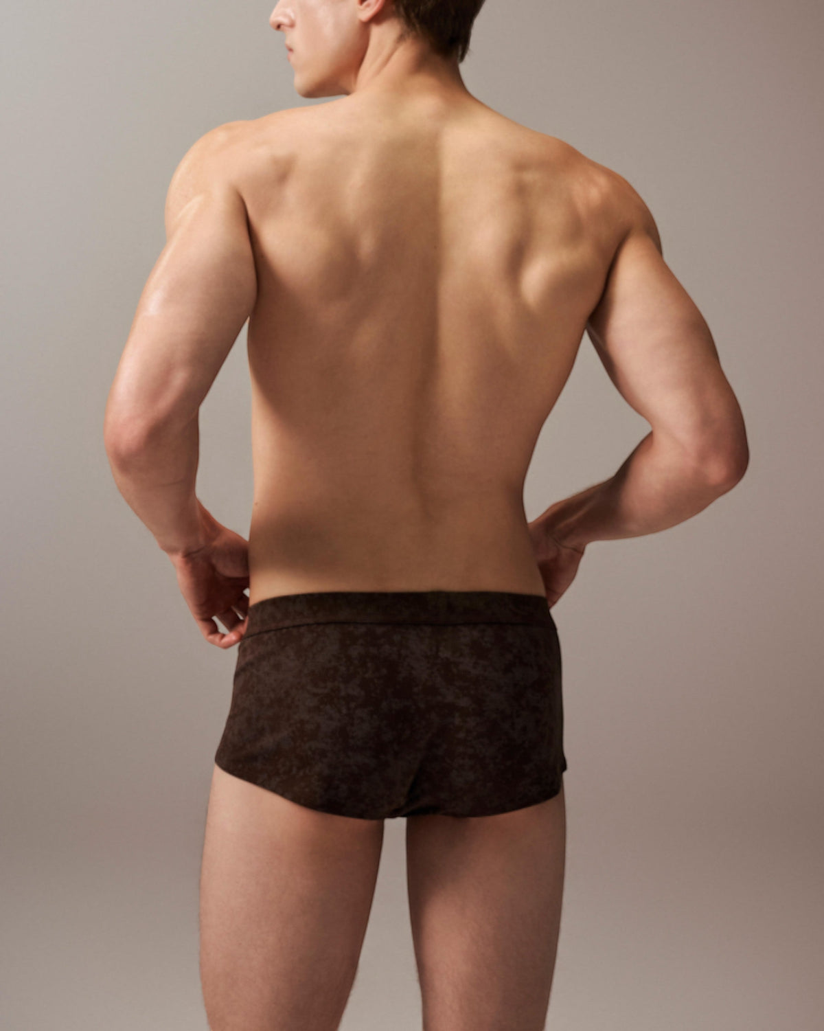 Model wearing the mottled brown BSZN slash-cut trunk, full-coverage rear view