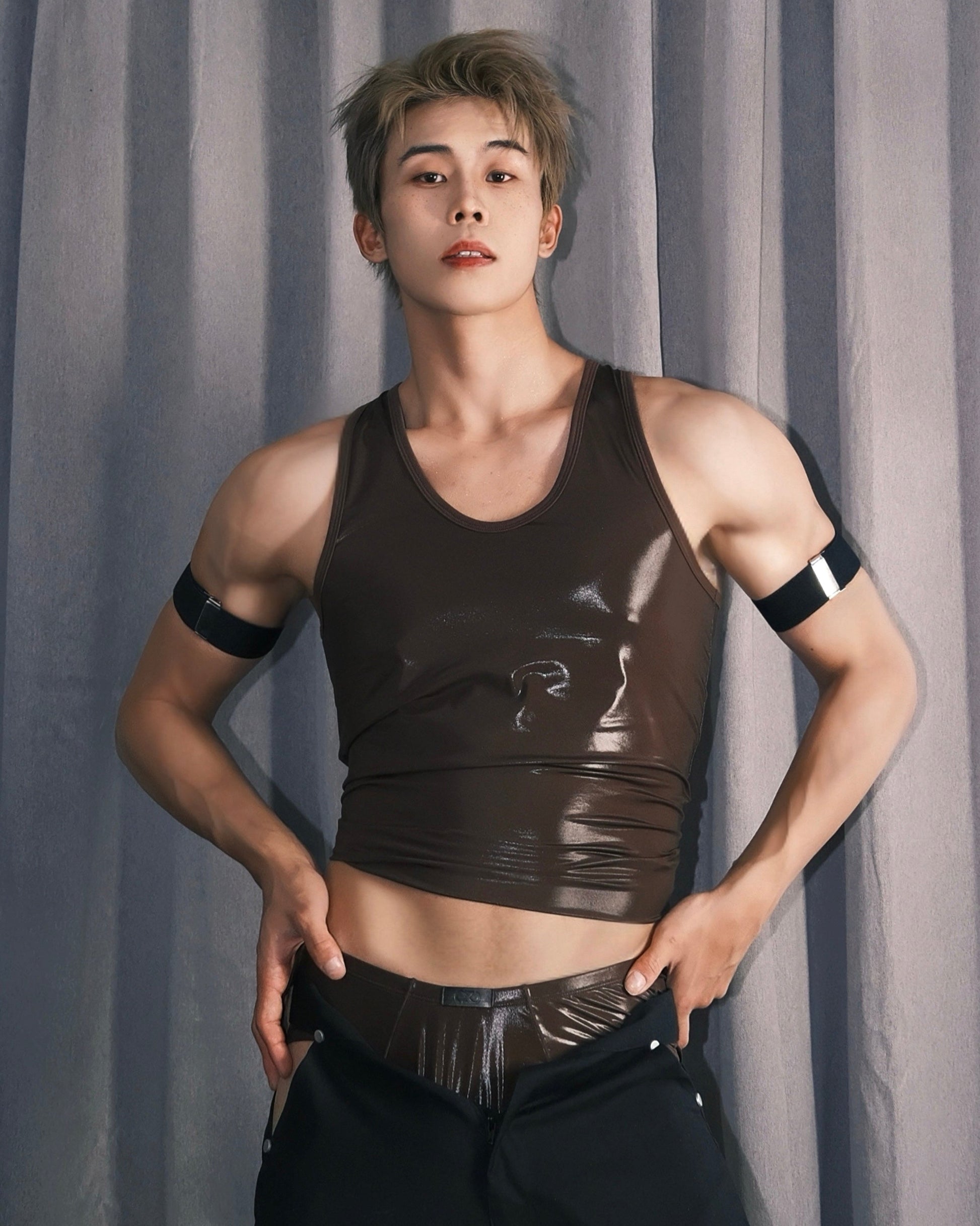 Model wearing the brown BSZN glossy racerback tank top, editorial front view