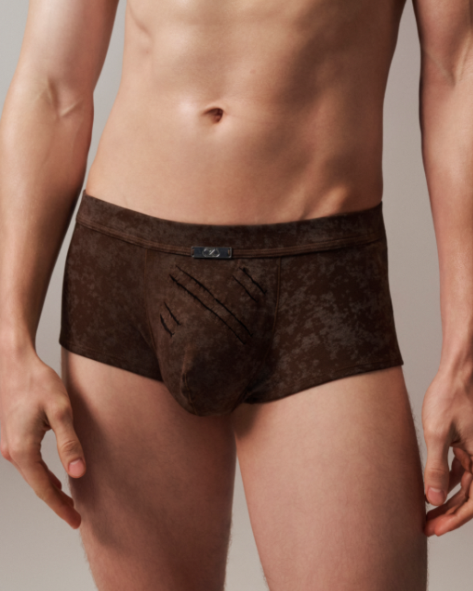 Model wearing the mottled brown BSZN Eternal Trace Slash-Cut Trunk, front view