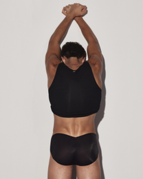 BSZN Black tank top on model, rear view with raised arms.
