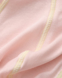 Close-up of the fine pink knit and contrast overlock seam