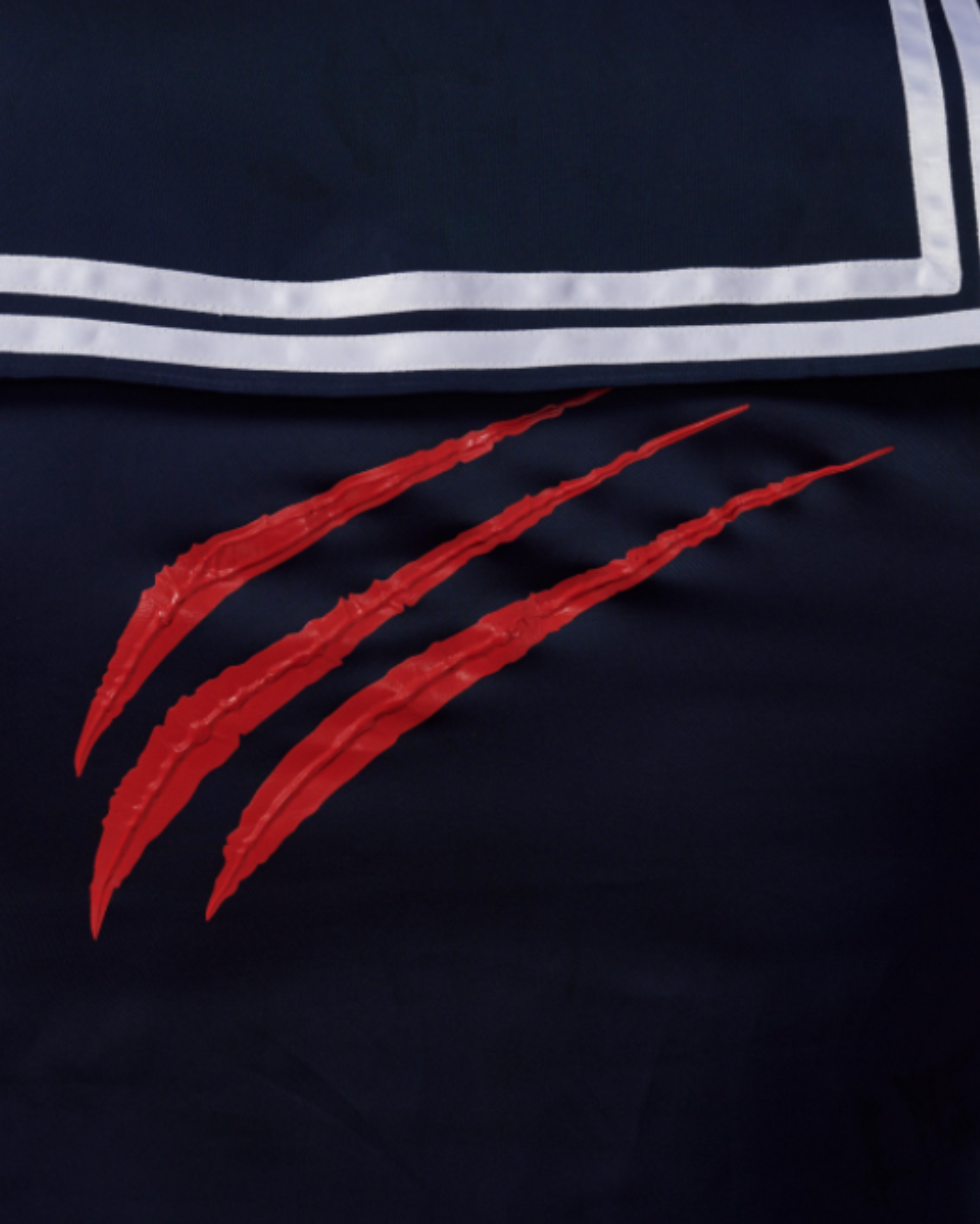 Close-up of the red claw mark beneath the sailor back flap