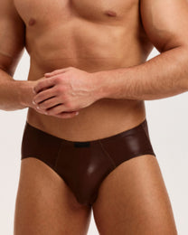 Model wearing the brown BSZN Liquid Skin Ruched-Back Brief, front view