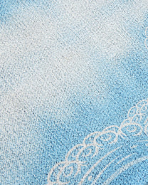 Close-up of the blue gradient knit and white tentacle linework