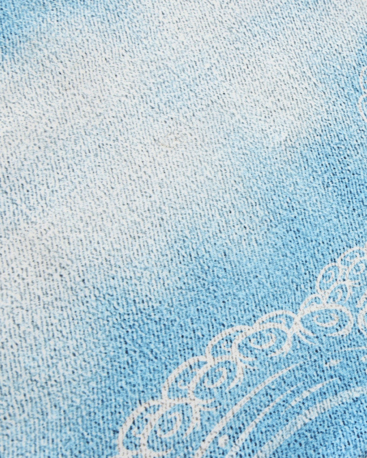 Close-up of the blue gradient knit and white tentacle linework