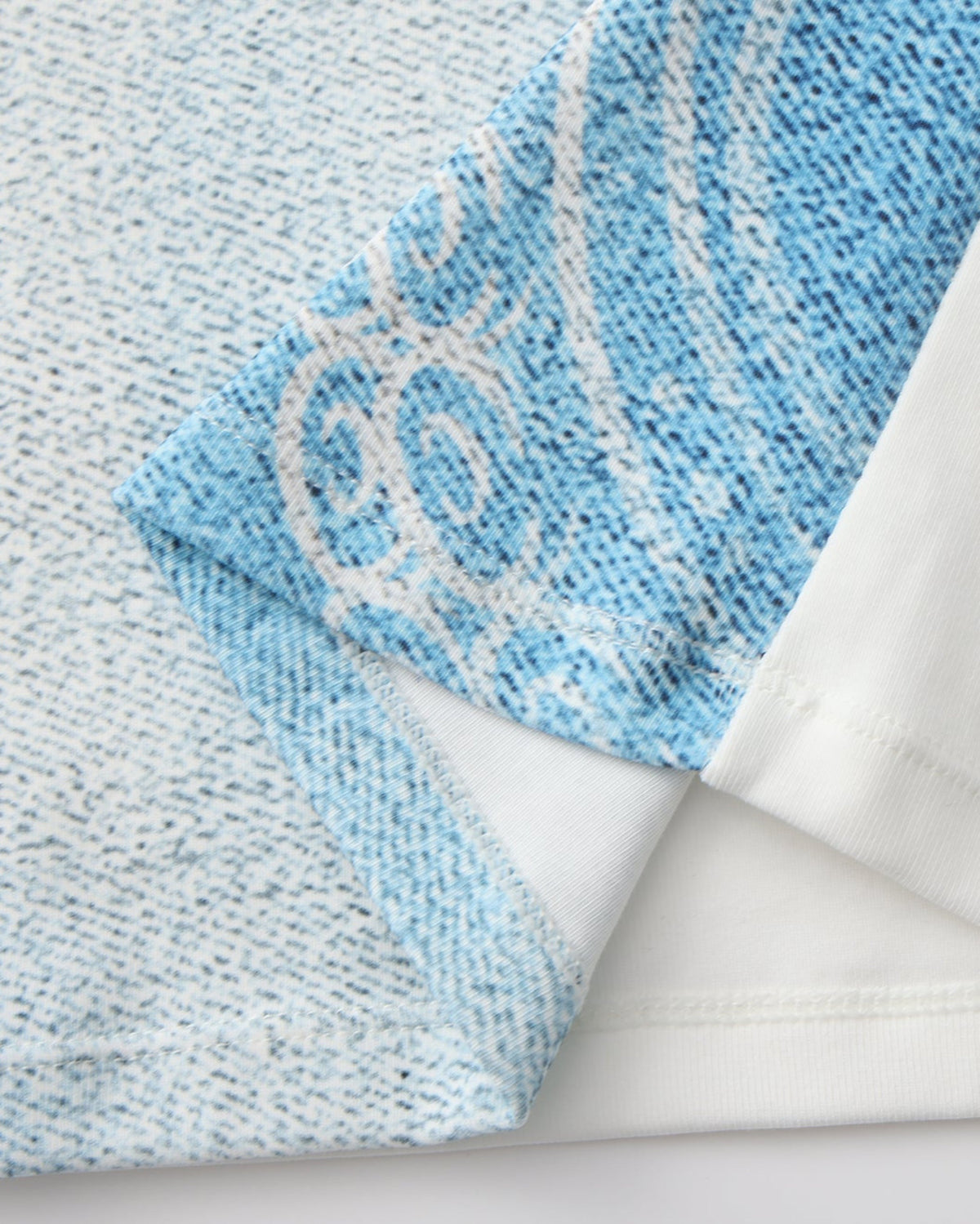 Close-up of the printed blue front panel beside the white back fabric