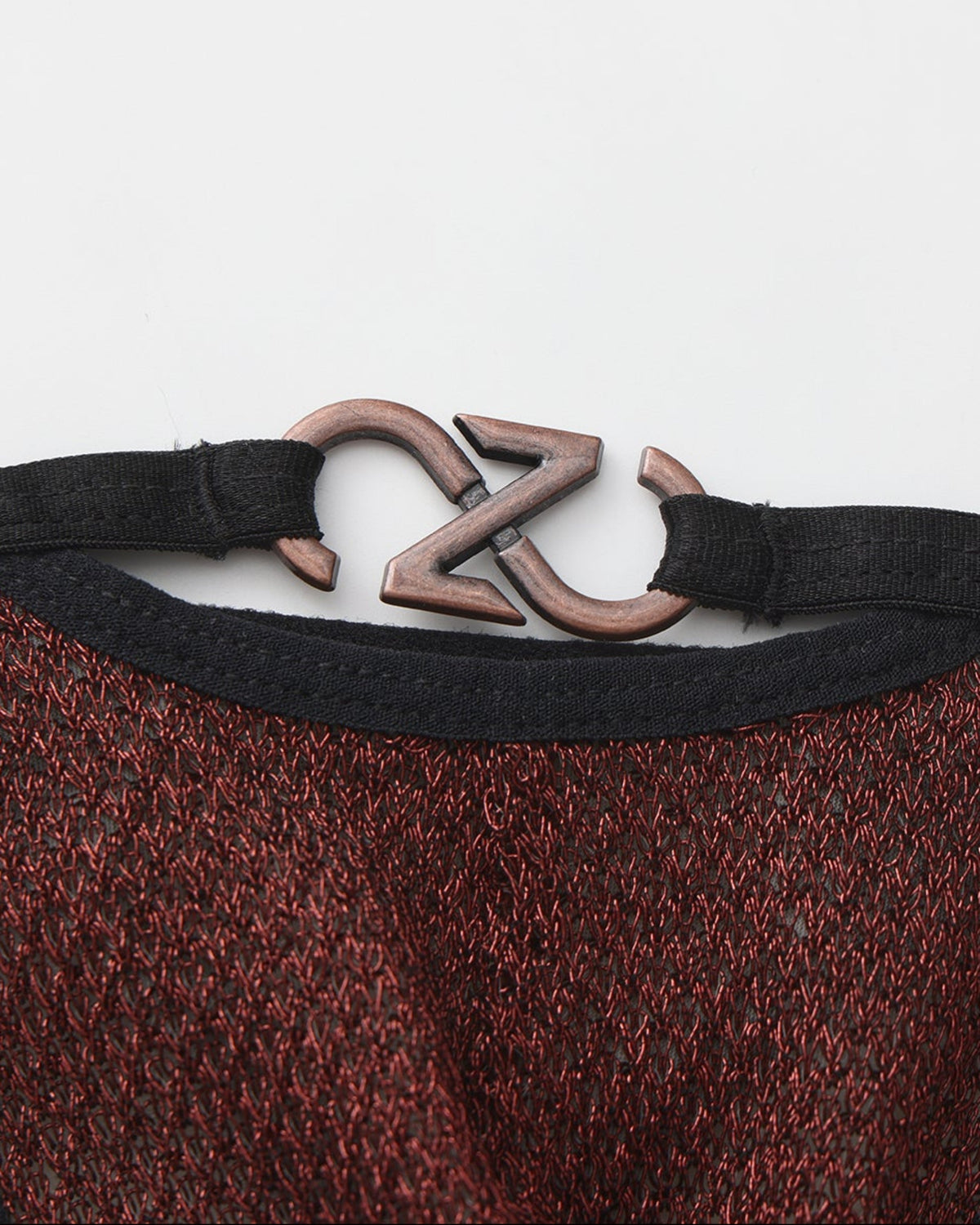 BSZN Metallic Pouch Logo Thong — Red metal logo close-up.