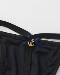 Close-up of the anchor charm and blue ribbon at the front
