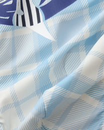 Close-up of the pale blue and white plaid stretch fabric