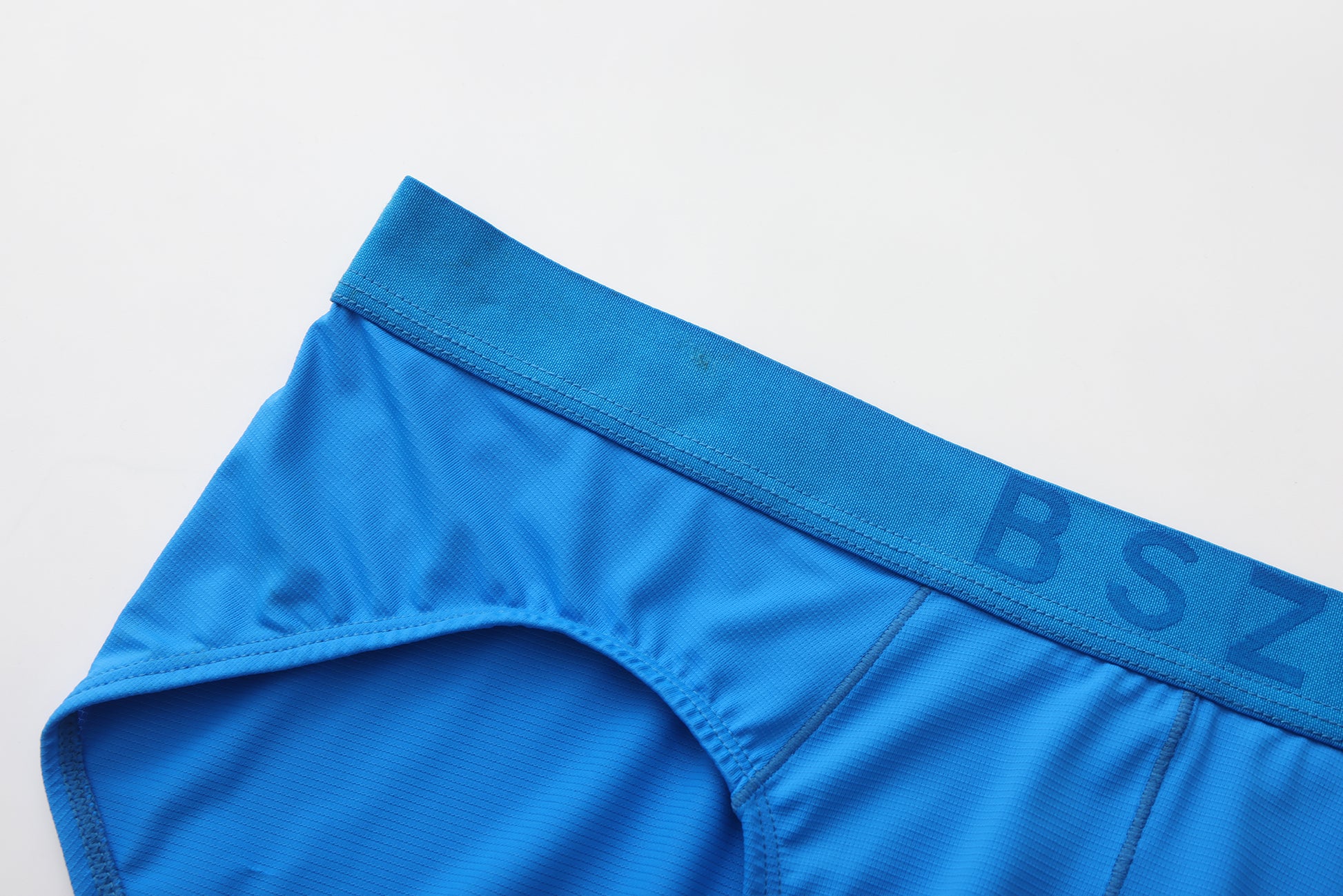 Close-up of the blue tonal BSZN waistband and micro-rib fabric