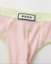 Close-up of the BSZN waist patch and pale yellow front seams