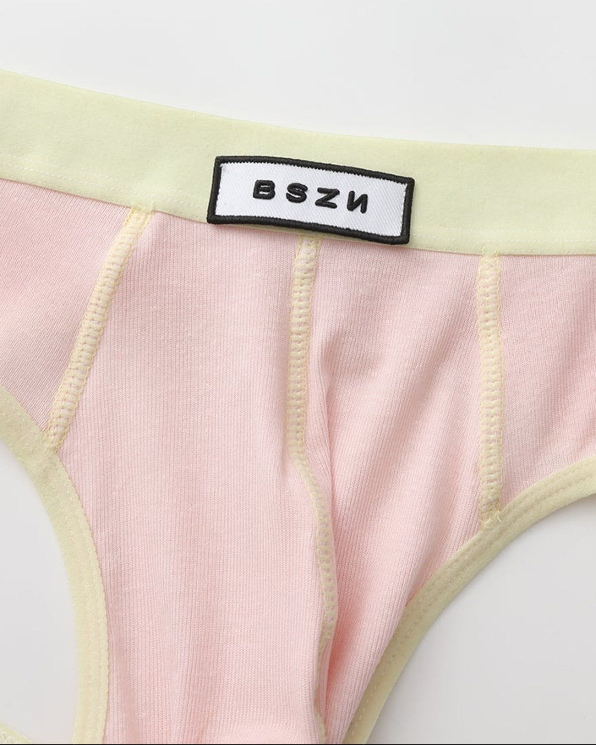 Close-up of the BSZN waist patch and pale yellow front seams