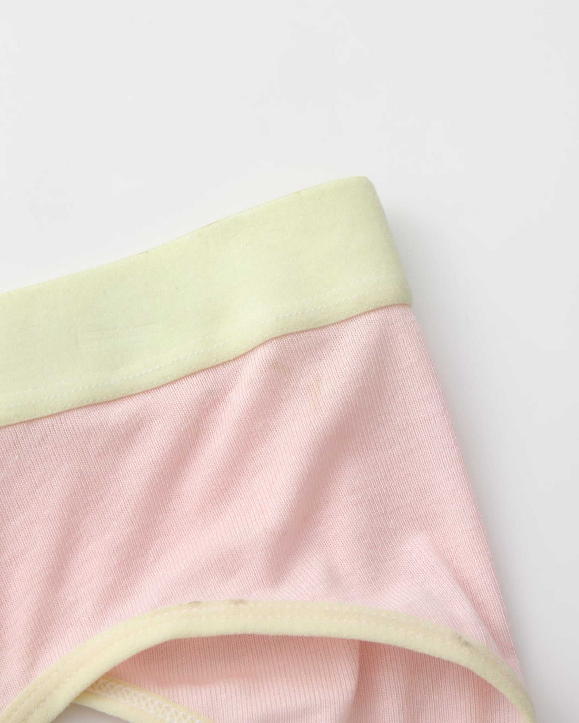 Close-up of the pink body with pale yellow waistband and leg binding