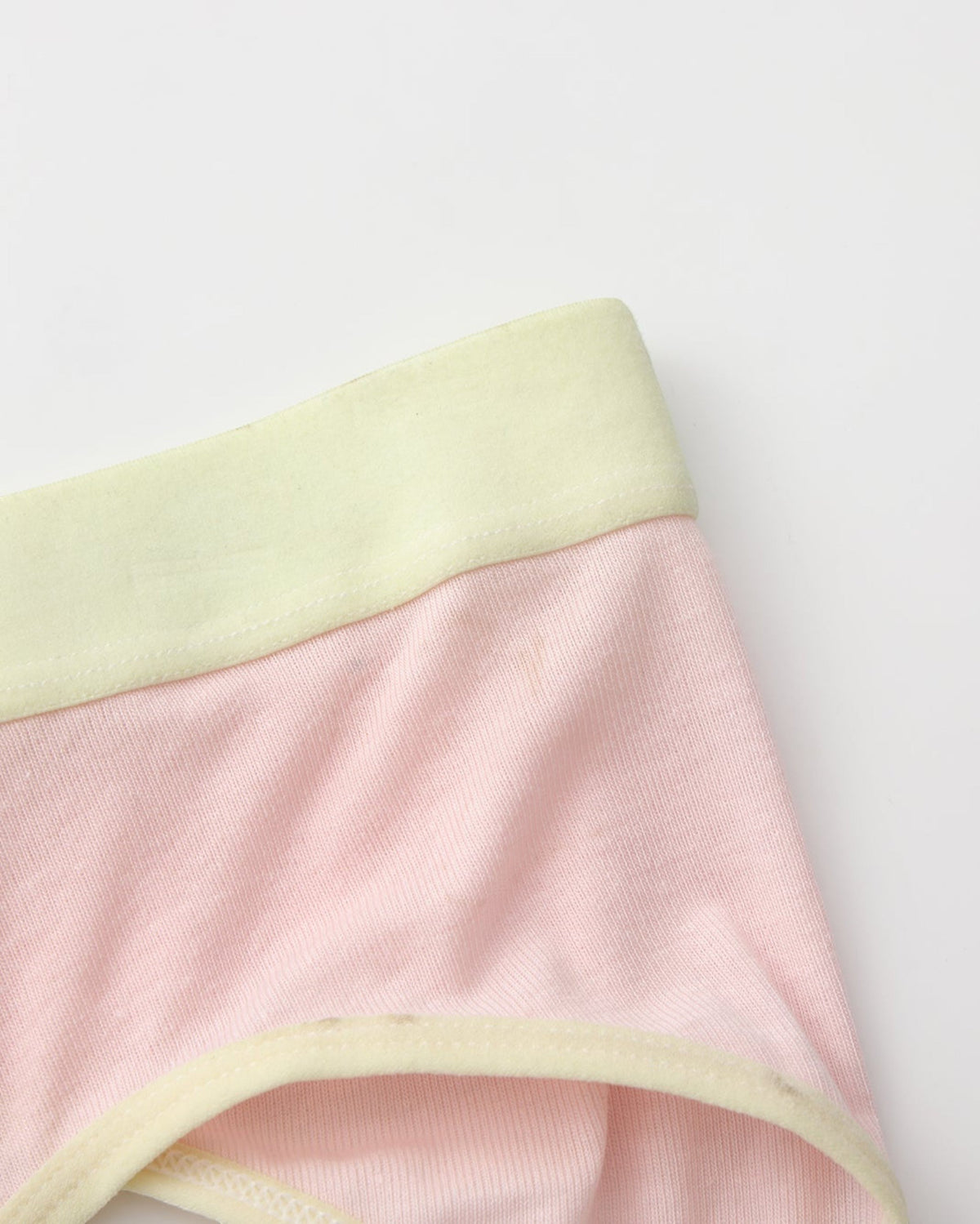 Close-up of the pink body with pale yellow waistband and leg binding