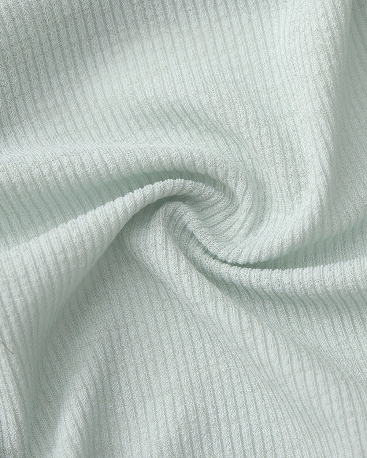 BSZN Crystal Veil V-Sculpt Brief — Pale green textured fabric close-up.