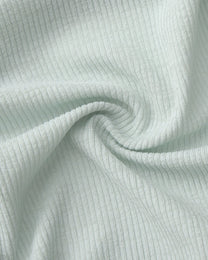 BSZN Crystal Veil V-Sculpt Brief — Pale green textured fabric close-up.