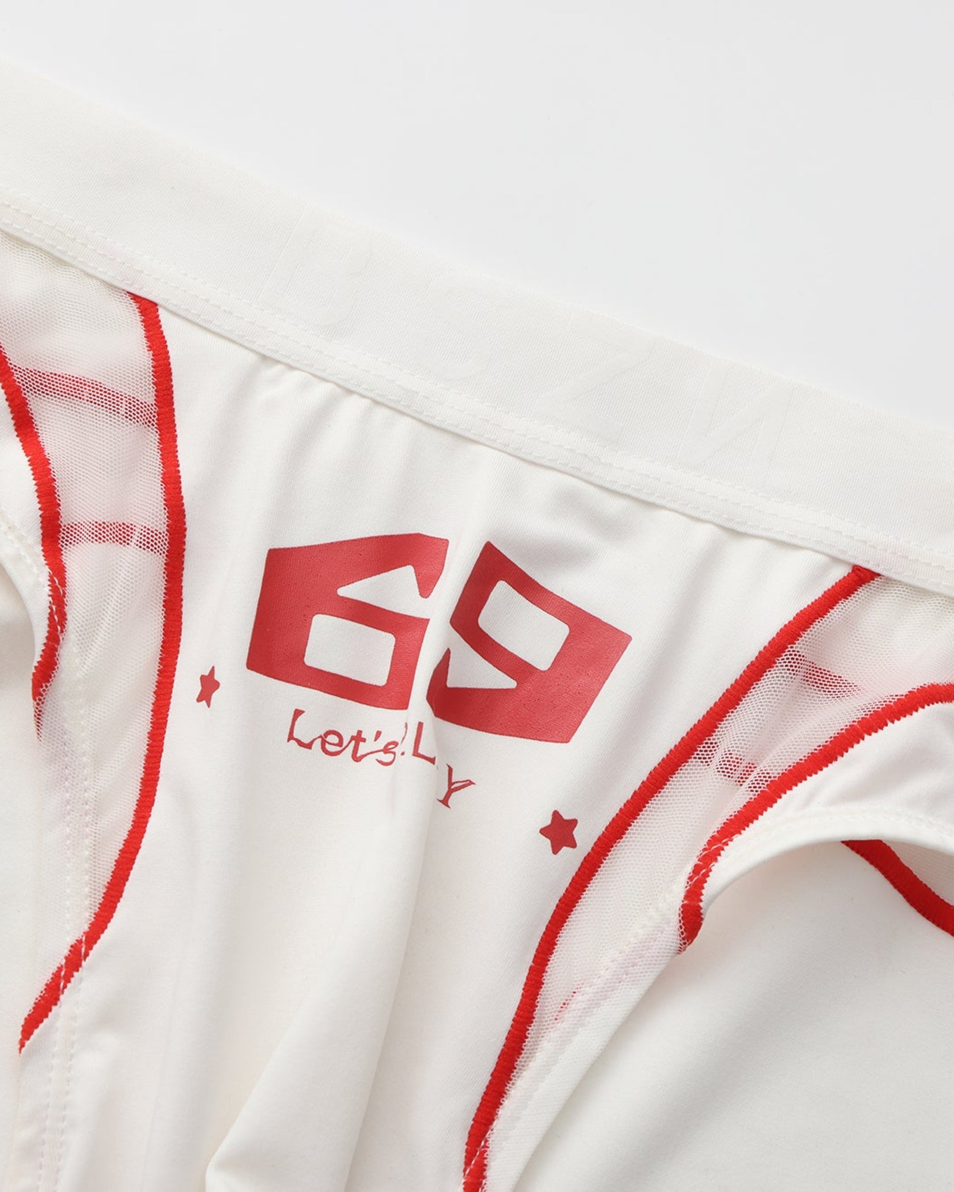 Close-up of the white 69 graphic, red piping and sheer mesh panel