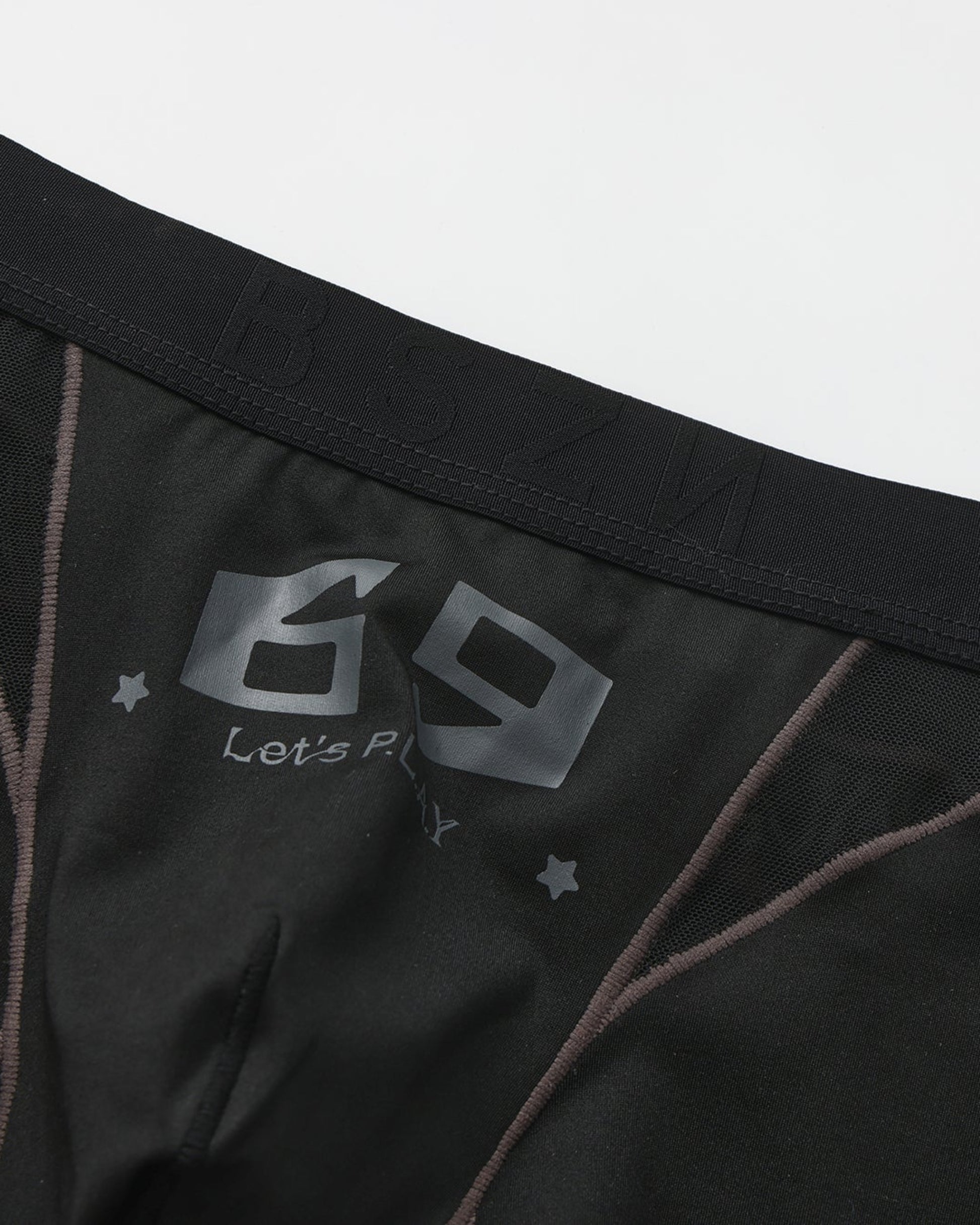 Close-up of the black 69 graphic and smoky contrast piping