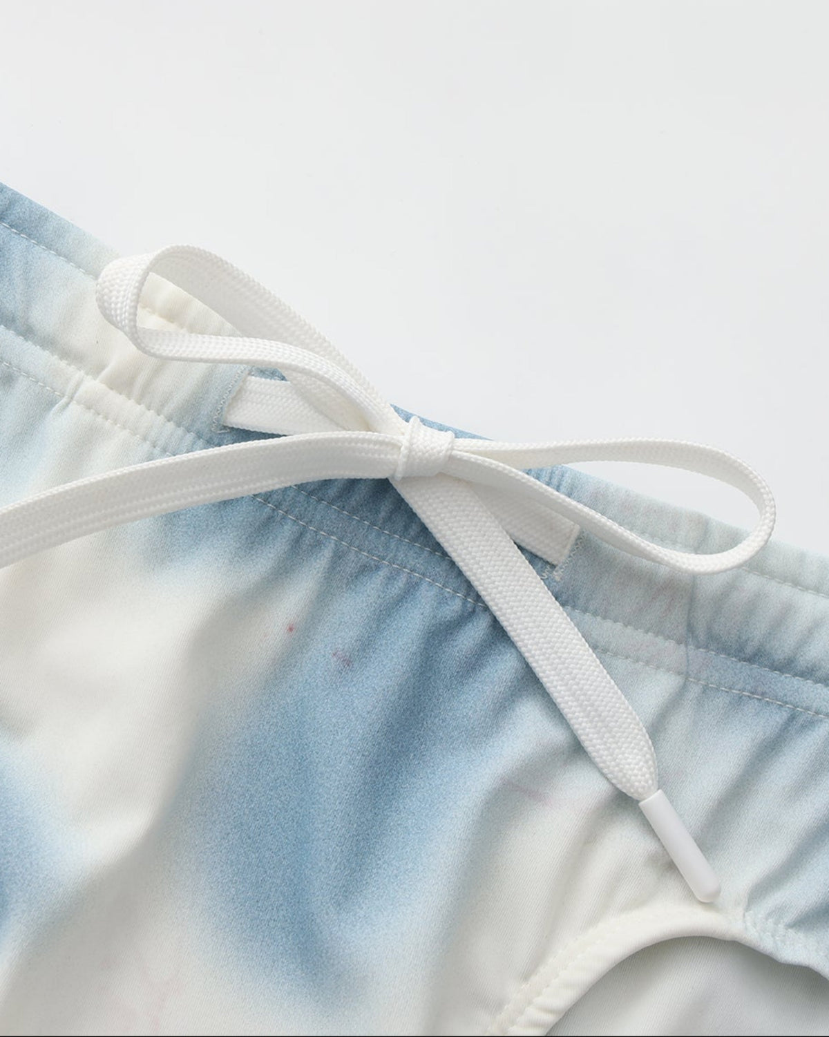 BSZN Dappled Print Swim Brief — Blue drawstring waist detail.