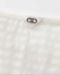 Close-up of the silver BSZN logo at the center rear waistband