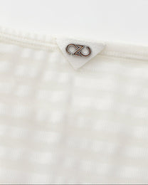 Close-up of the silver BSZN logo at the center rear waistband