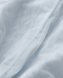 Close-up of the pale blue leopard mesh and opaque pouch-lining edge