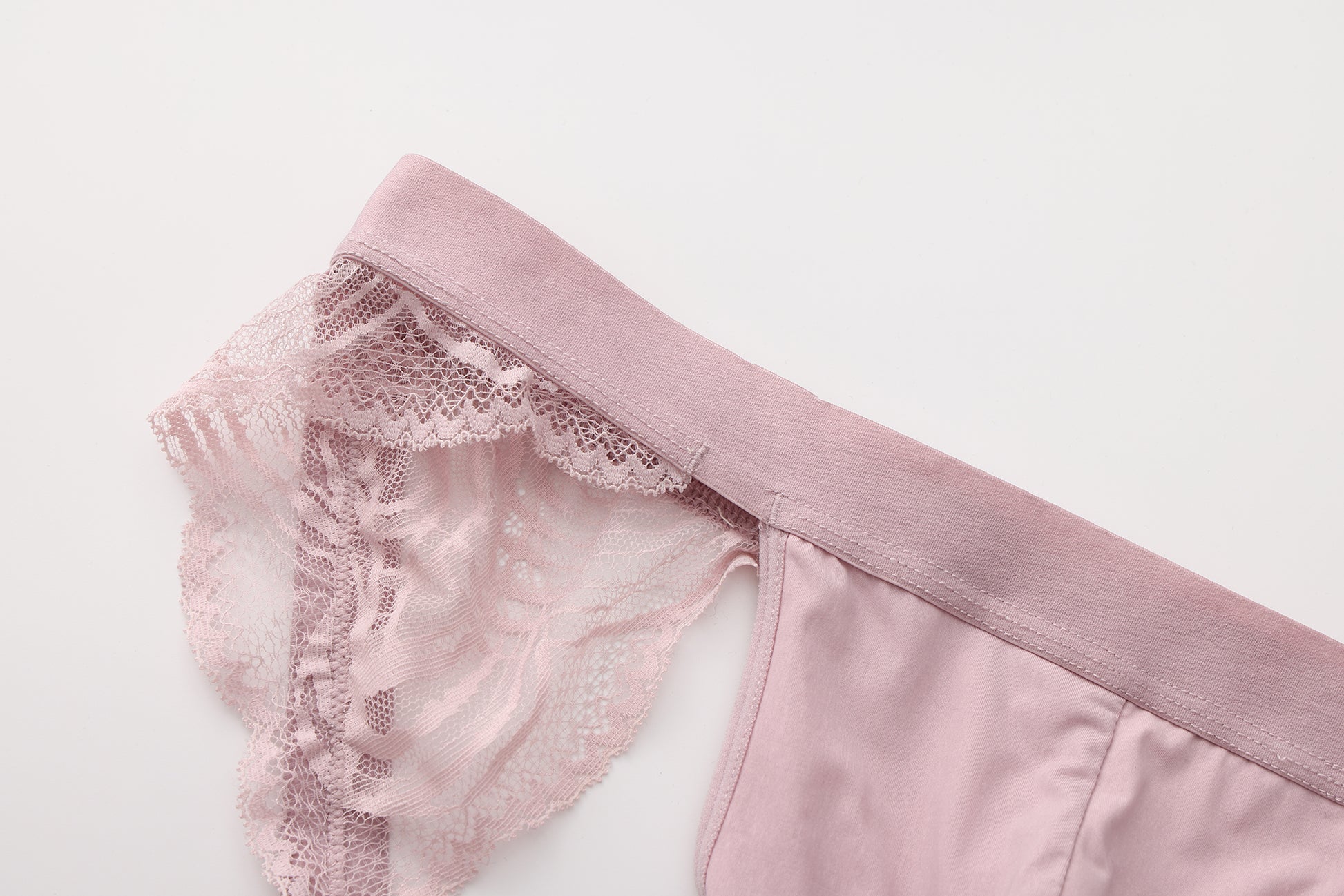 Close-up of pink scalloped lace framing and elastic waistband