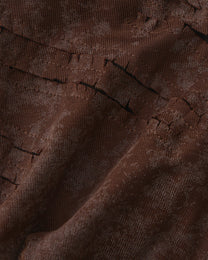Close-up of the diagonal front cutouts and mottled brown stretch jersey