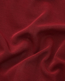 Close-up of the gathered deep red fine-mesh fabric