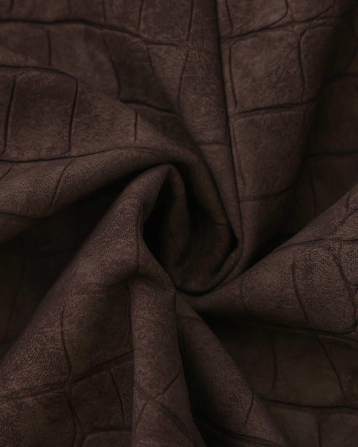 Close-up of the gathered brown reptile-embossed viscose texture