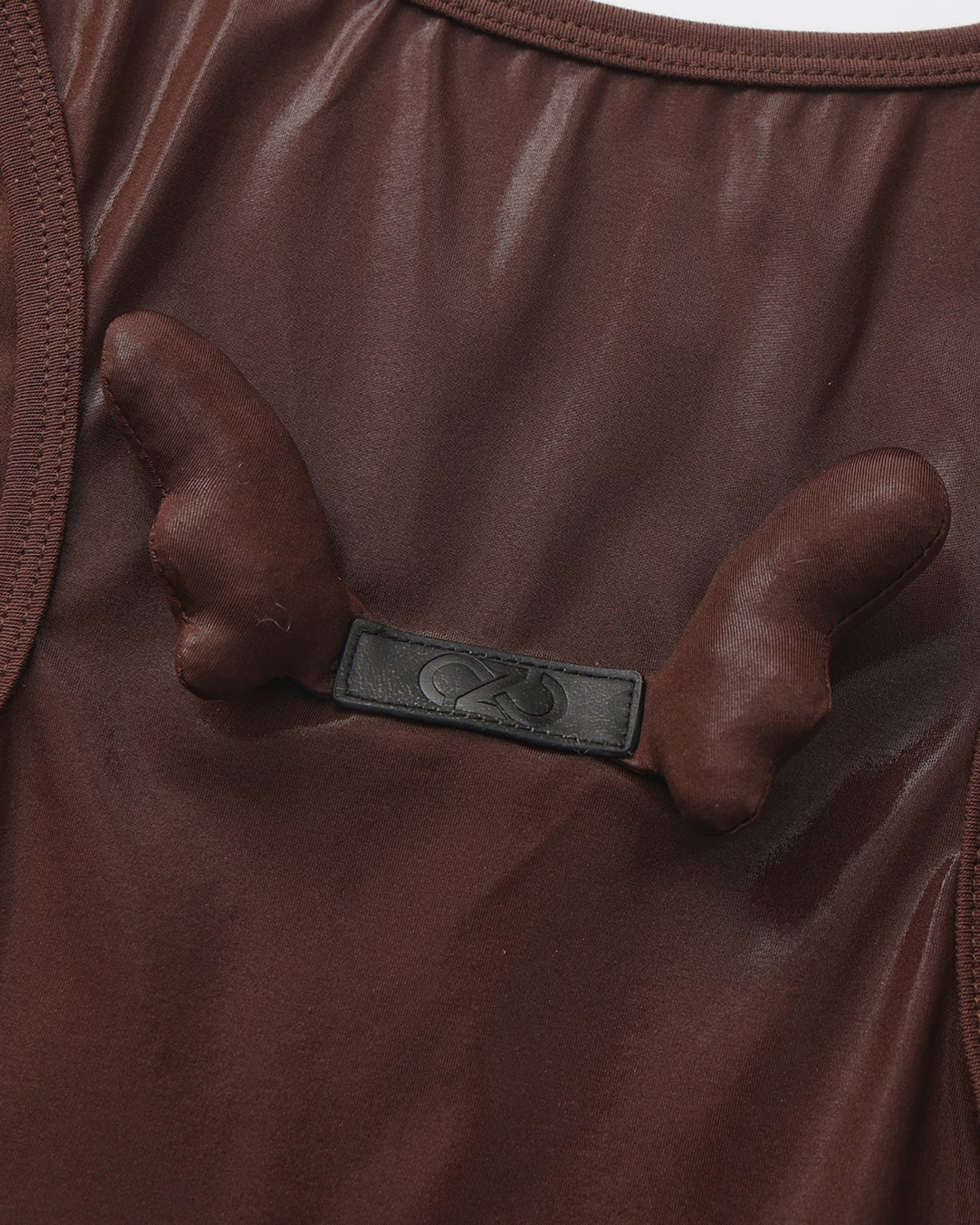 Close-up of the paired sculptural detail on the BSZN upper-back logo tab