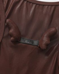 Close-up of the paired sculptural detail on the BSZN upper-back logo tab