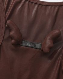 Close-up of the paired sculptural detail on the BSZN upper-back logo tab