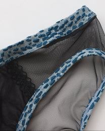 Close-up of blue animal-print binding and sheer black mesh