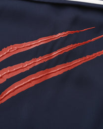 Close-up of the raised red claw-mark applique texture