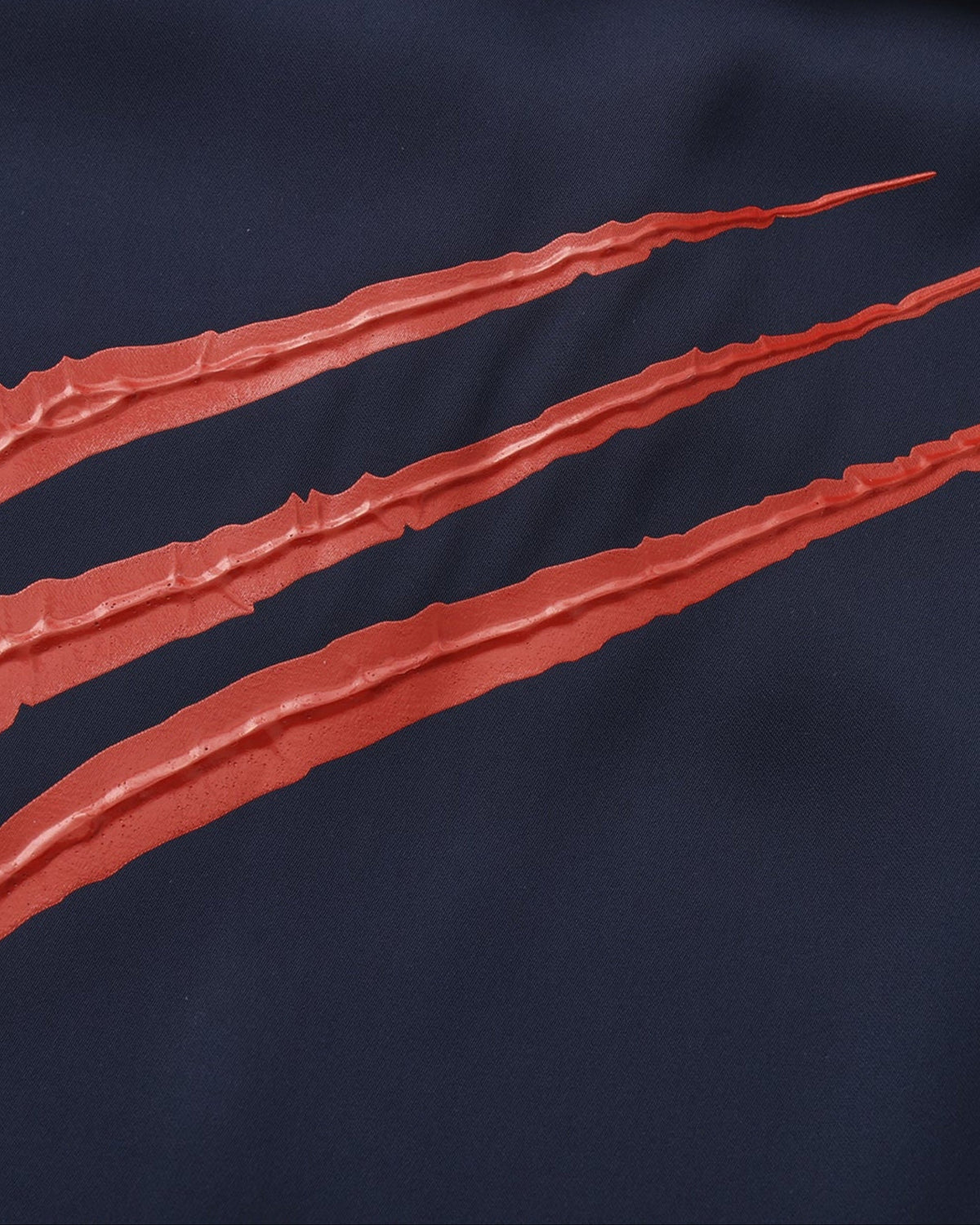 Close-up of the raised red claw-mark applique texture