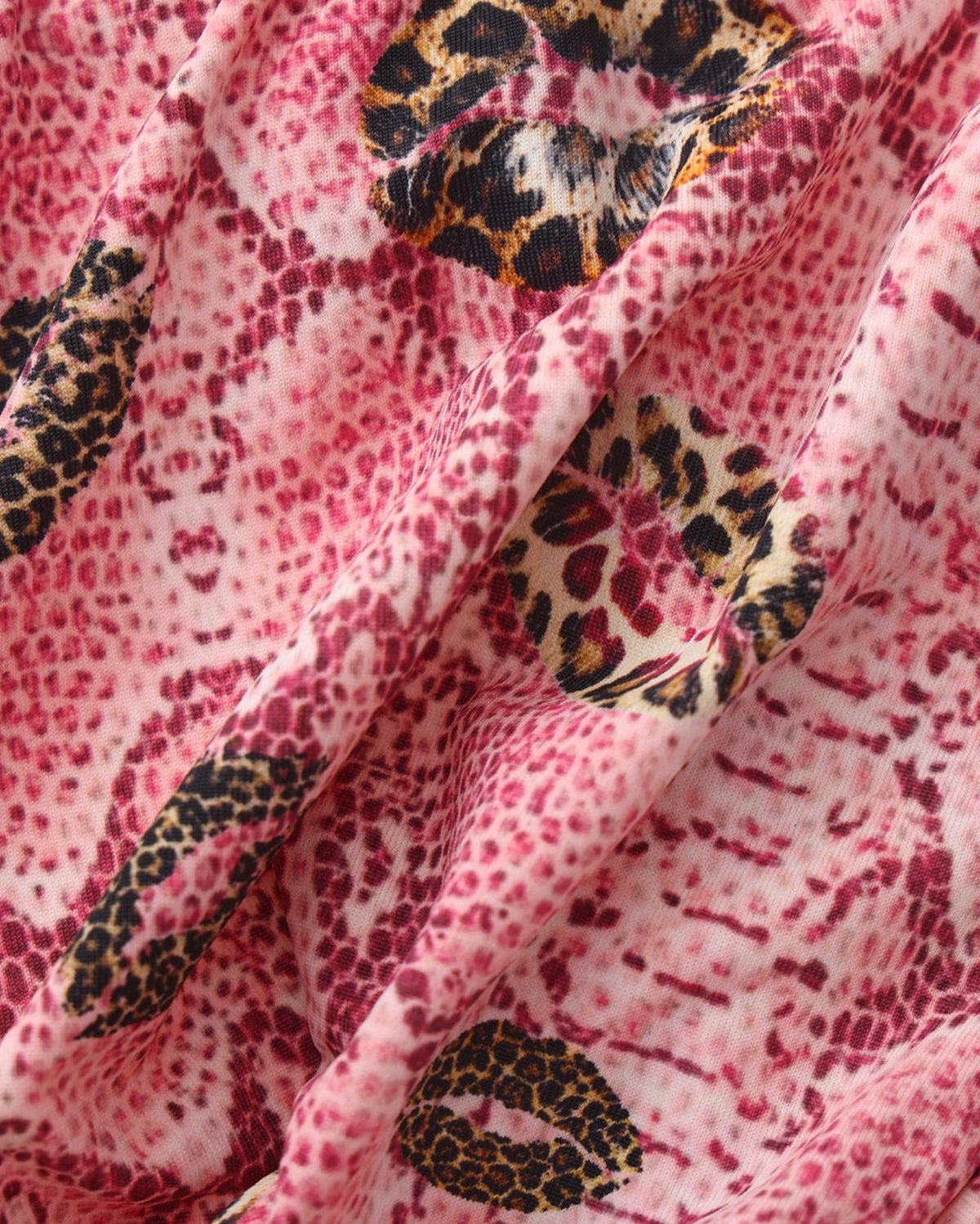 BSZN Wild Kiss Open-Back Trunk — Pink snakeskin and kiss motif close-up.