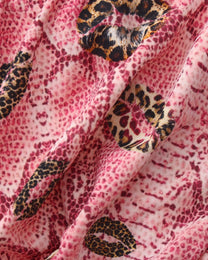 BSZN Wild Kiss Open-Back Trunk — Pink snakeskin and kiss motif close-up.