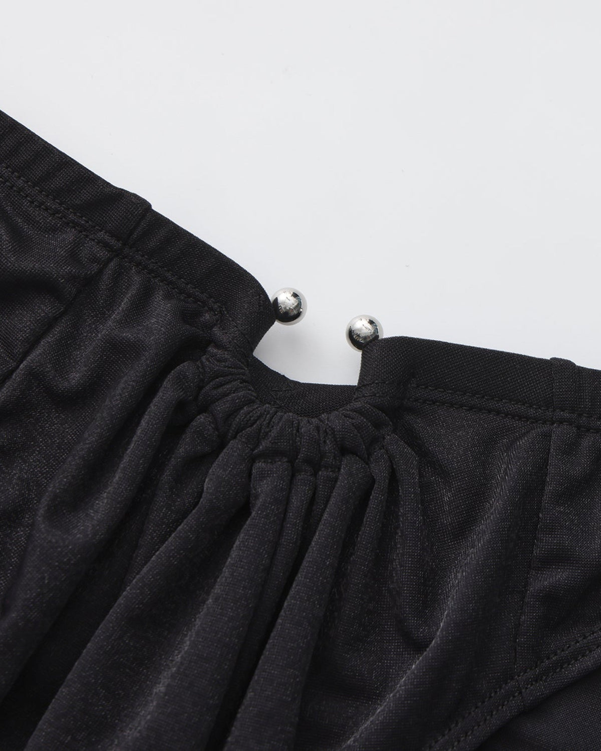 BSZN Shimmer Horseshoe Ring Brief — Black horseshoe ring close-up.