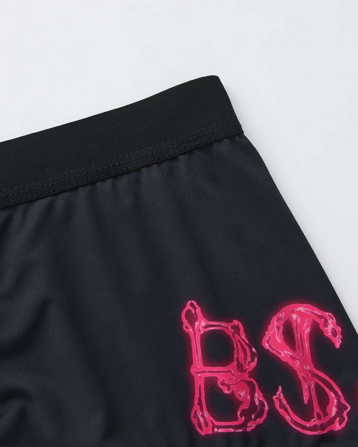 BSZN Pink BSZN lettering and waistband, close-up.