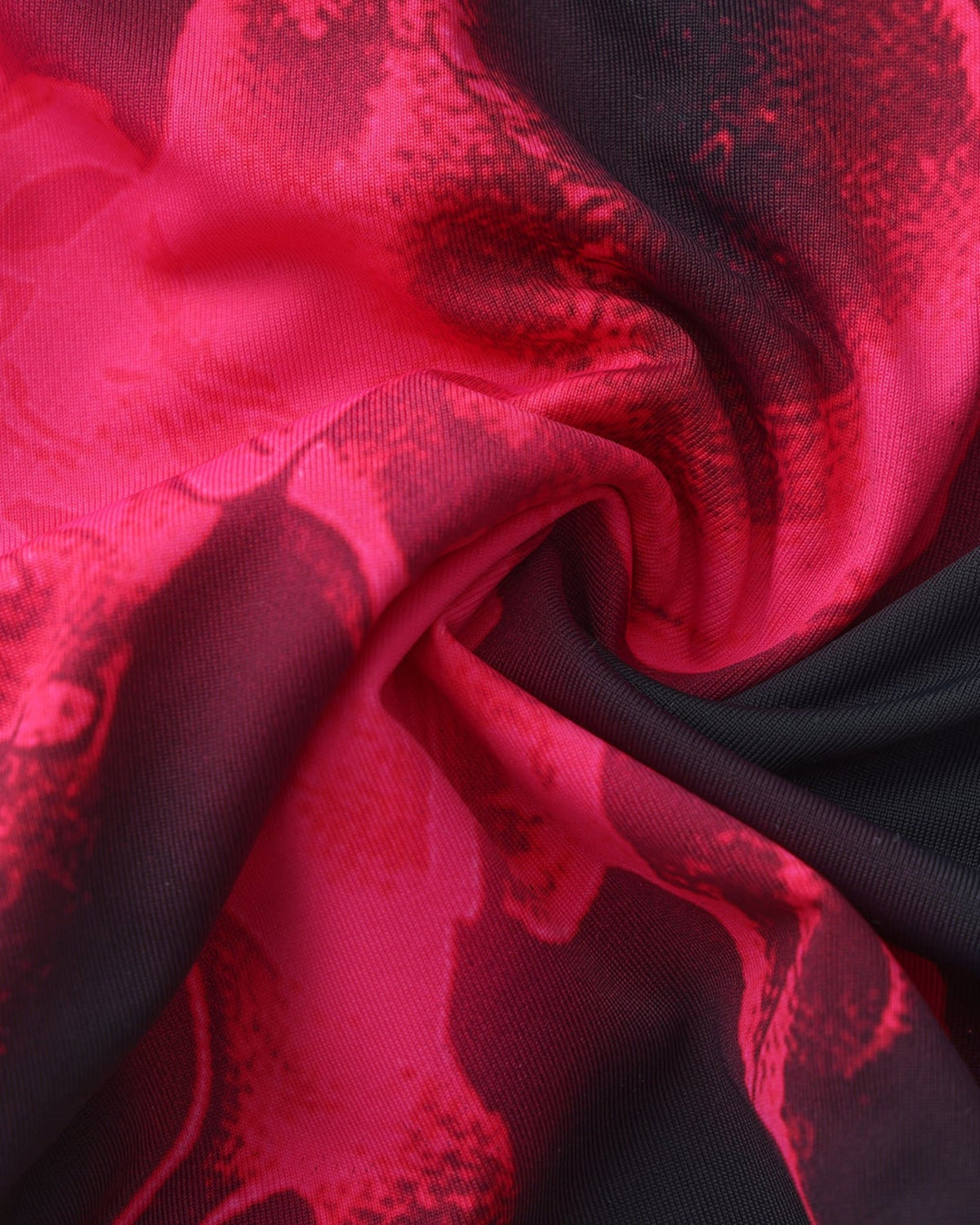 BSZN Pink skeletal print on folded black fabric, close-up.