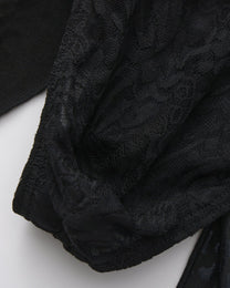 BSZN Patterned black lace pouch, close-up.