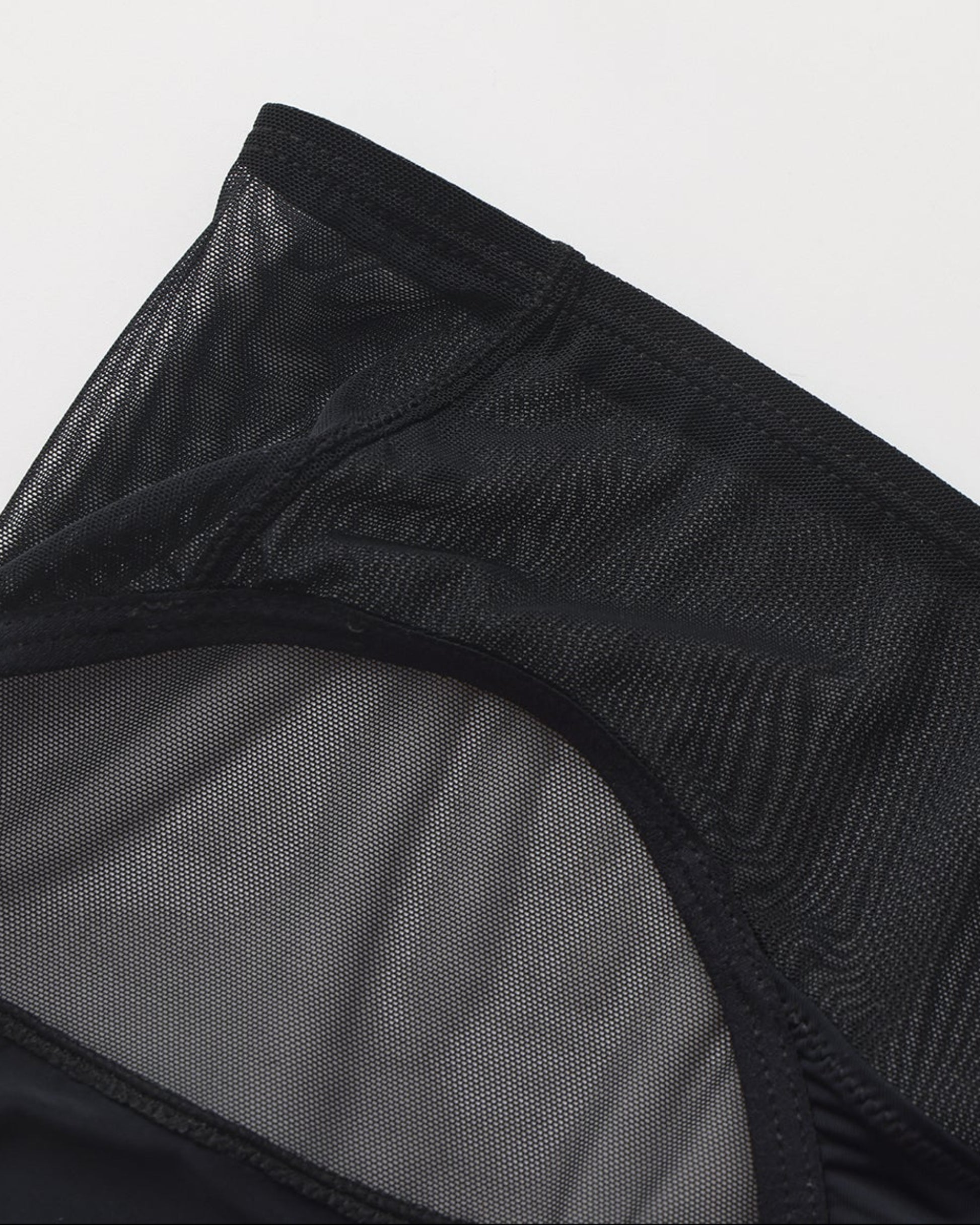 Close-up of sheer mesh and asymmetric panel construction