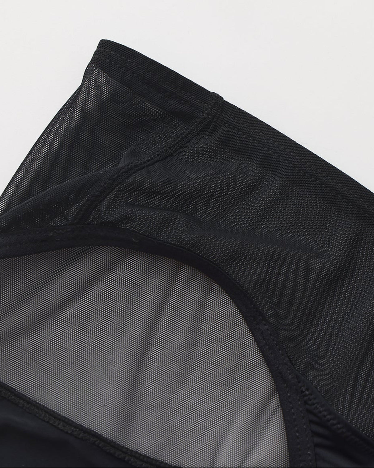 Close-up of sheer mesh and asymmetric panel construction