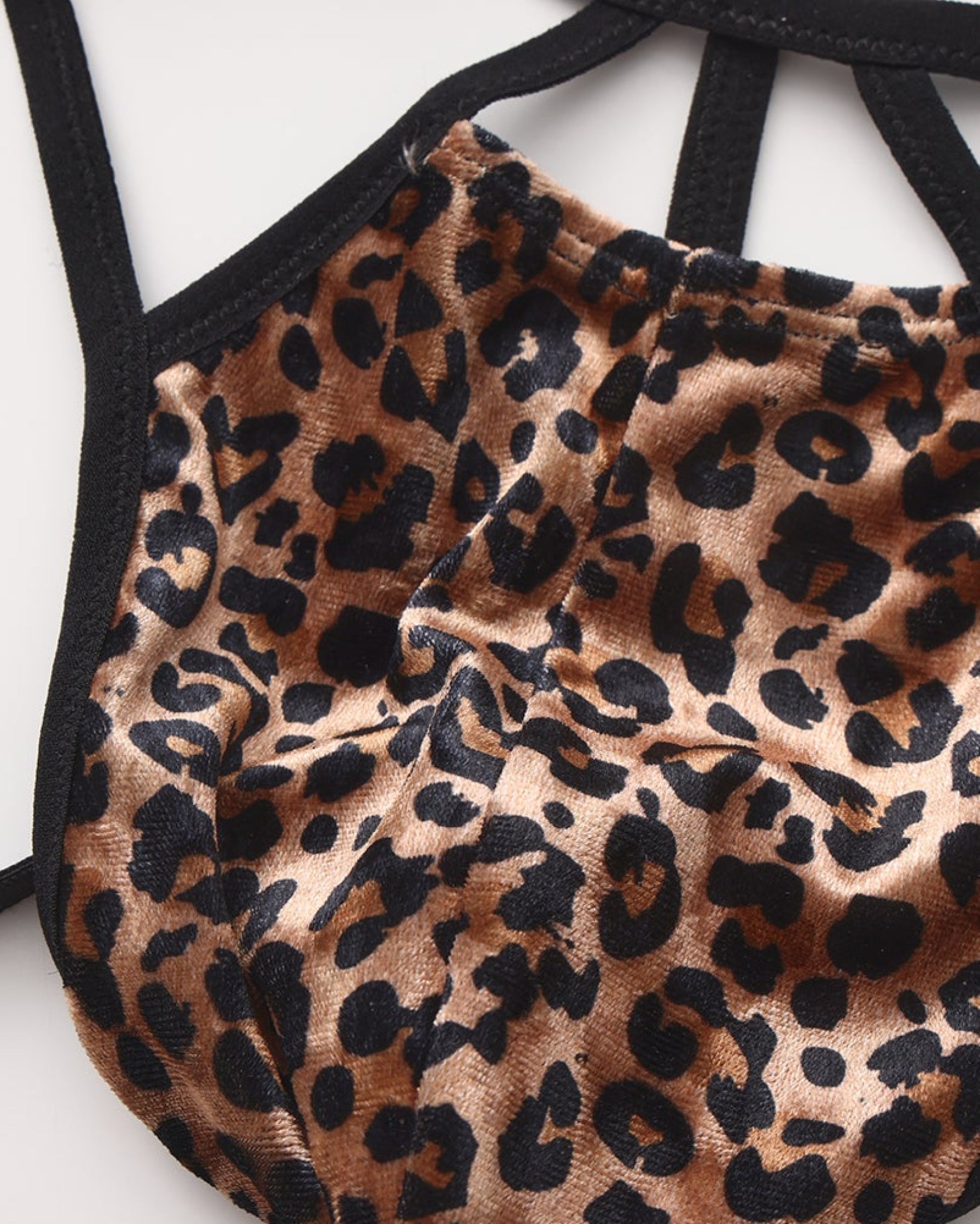 Close-up of the leopard pouch seam and black binding on the BSZN cage thong