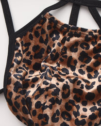 Close-up of the leopard pouch seam and black binding on the BSZN cage thong