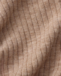 Close-up of the brown ribbed stretch fabric and seam texture